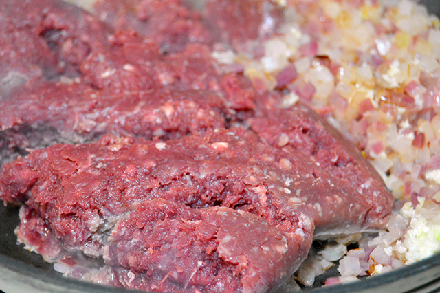 browning bison meat in skillet