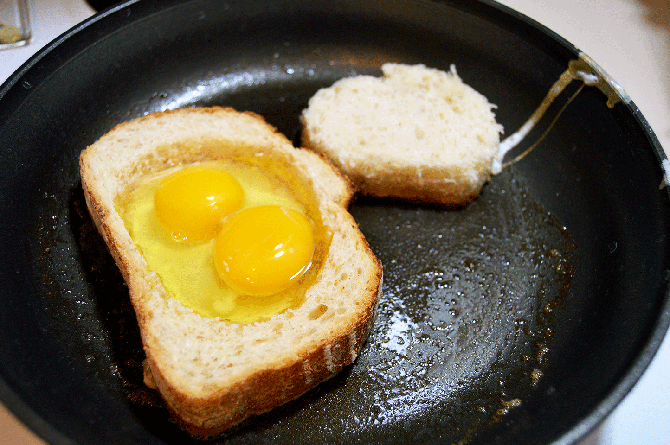 cracked eggs in center of bread