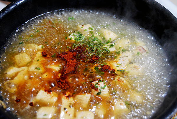 simmering in sauce