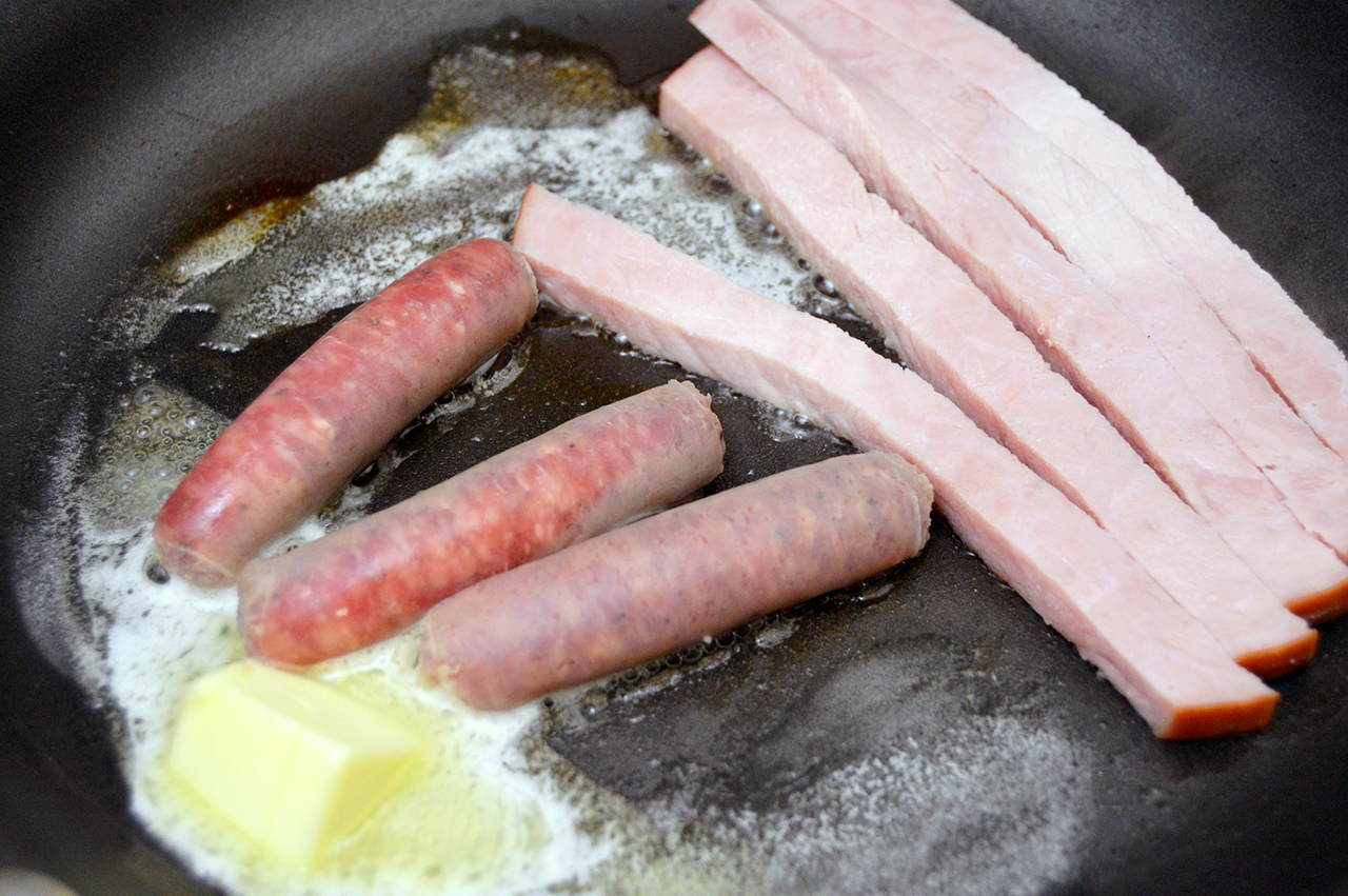 frying sausage and ham
