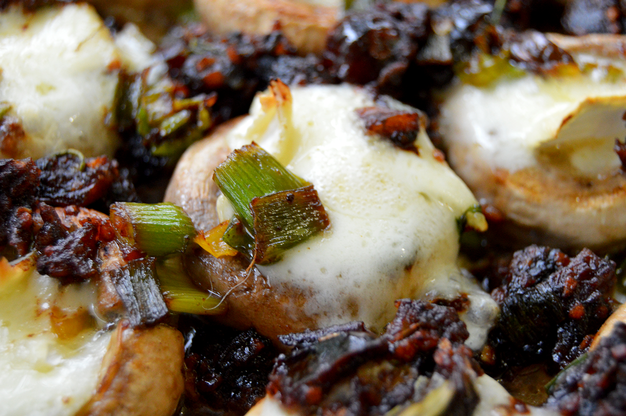close up of mushroom cap with brie and dates