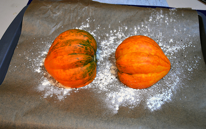acorn squash on a baking sheet