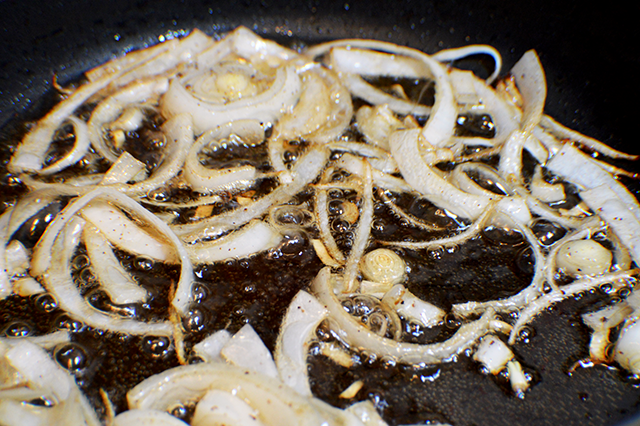 onions frying in pan
