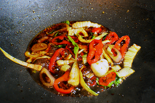 simmering sauce in wok