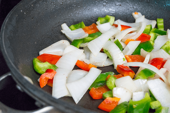 peppers and onions in skillet