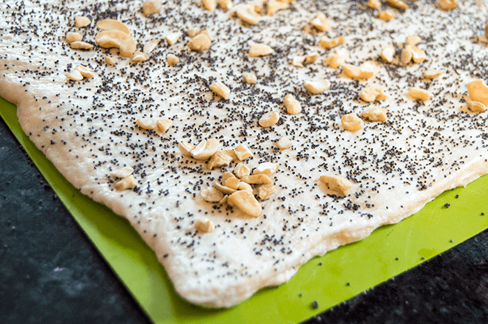 poppy seeds and cashews on dough