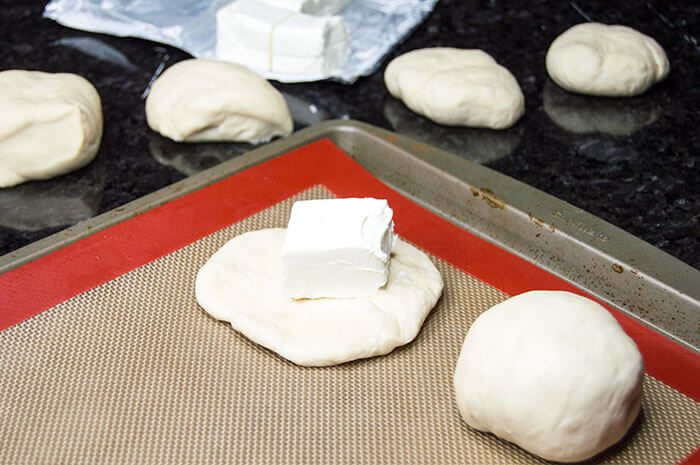 stuffing bagel dough with cream cheese