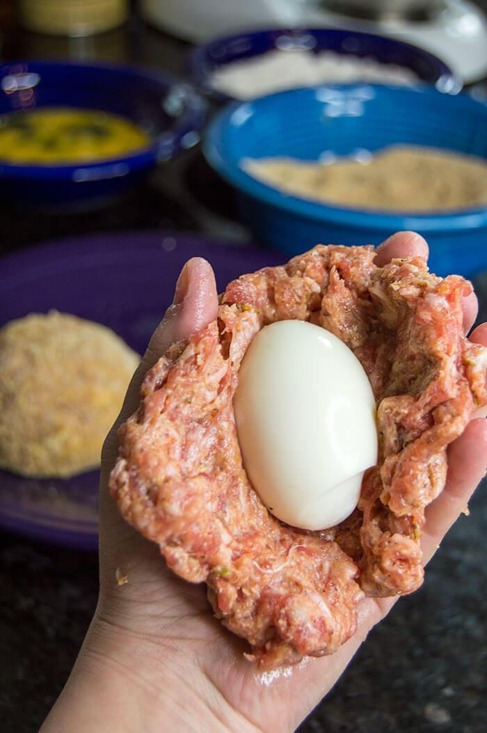 wrapping boiled eggs in meat