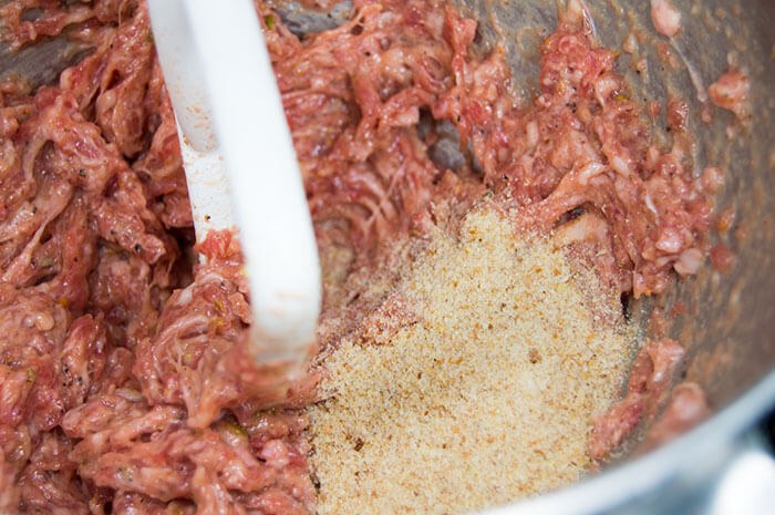 mixing meat with bread crumbs