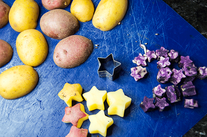cutting potatoes into stars with a cookie cutter