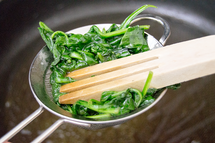 straining spinach