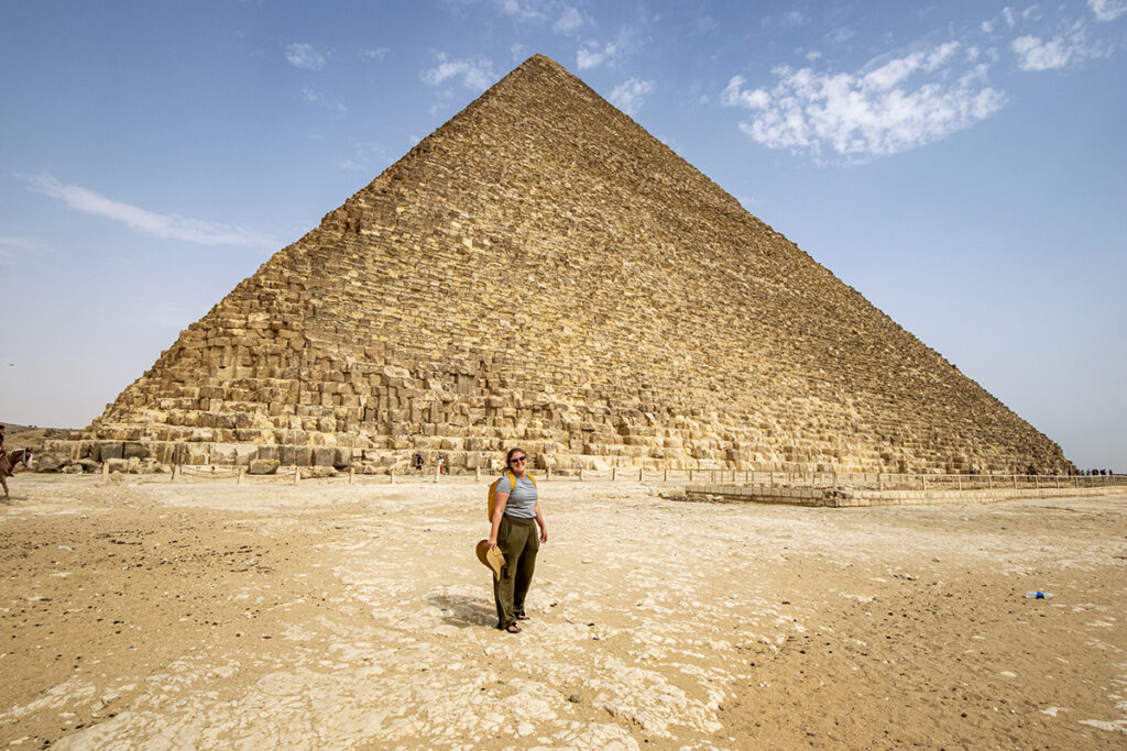 standing in front of pyramid